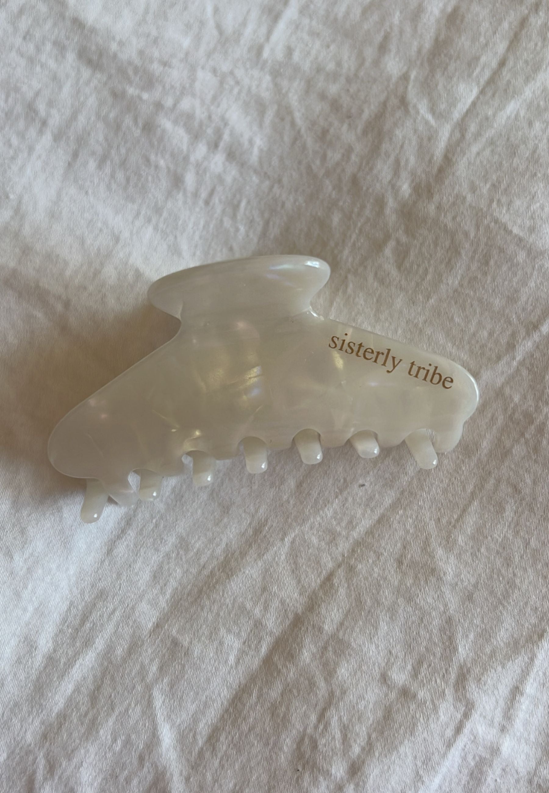 Sisterly Tribe Hair Claw, Colour Pearl and with Logo on one side.
